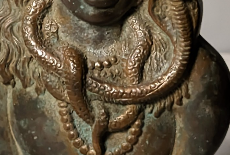 A brass antique from the collection, lit from below